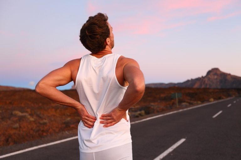 A man has back pain while running